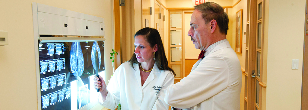 Members of the Weill Cornell Breast Center team reviewing a scan.