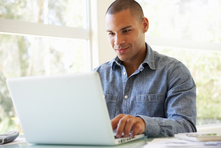 Man sitting at a desk using a laptop